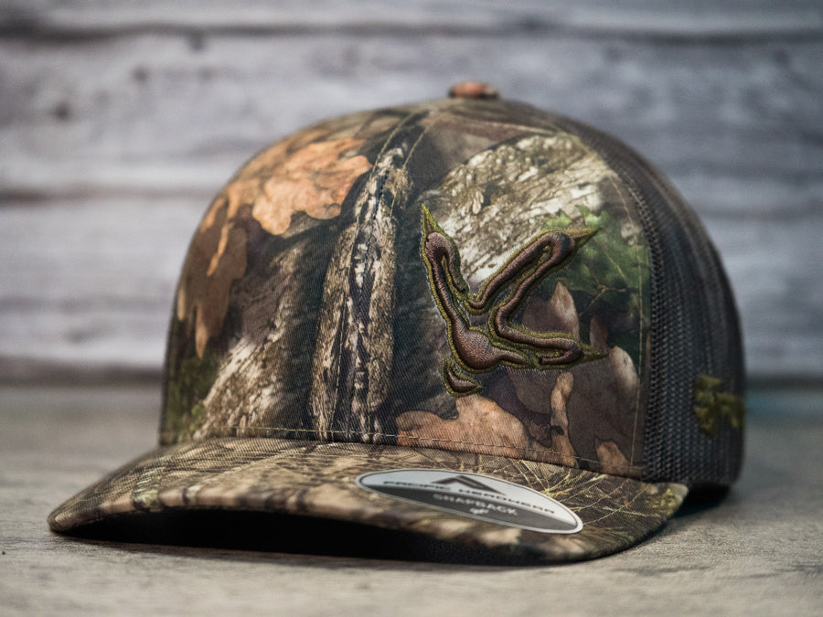 Turkey Track 3D Olive Side Panel Logo on MossyOak Country- Pacific Headwear 108C Snap-Back Cap